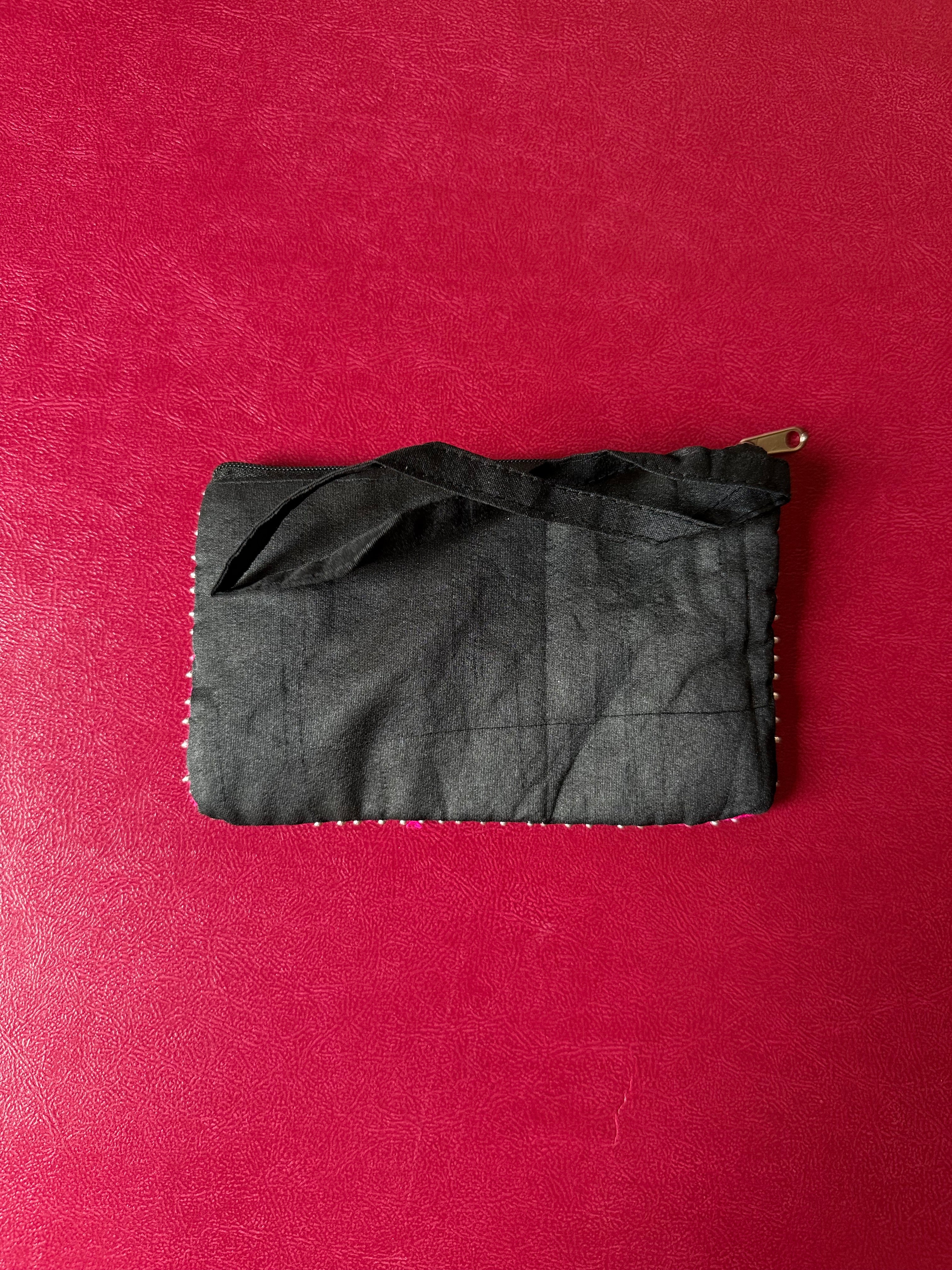 Flower embellished pouch